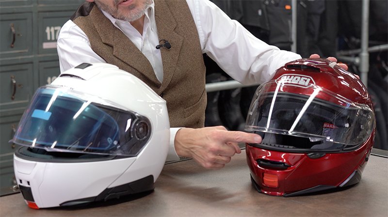 Chris showing crack positions on Schuberth C5 and Shoei Neotec 2 helmets